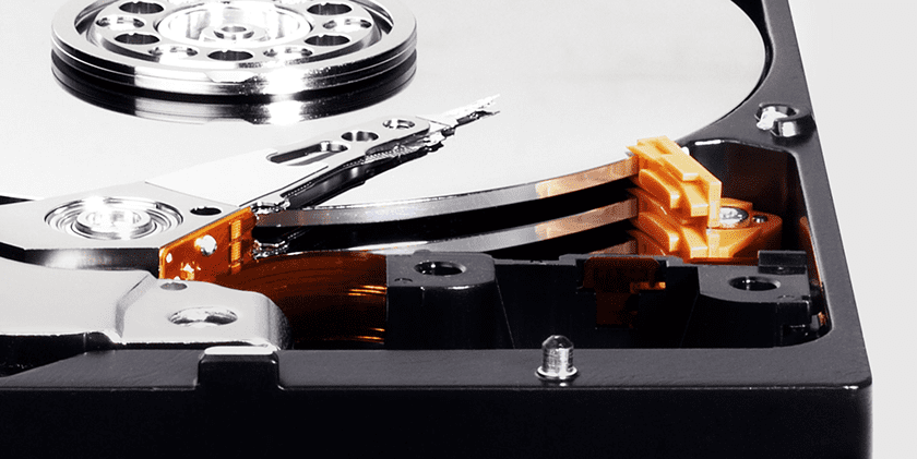 Partial view of internal structure of an HDD, showing disks, recording arm and head, coil, and more